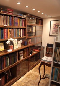 Inside Books & Ink Bookshop: glass-fronted oak cases of antiquarian books at 6 North Street, Winchcombe